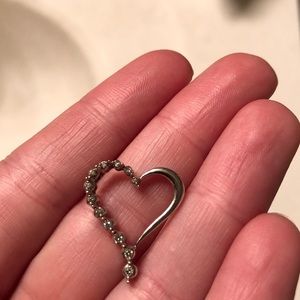 A Zales 10 karat white gold diamond heart pendant.